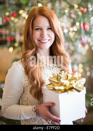 Studioaufnahme Mitte Erwachsene Frau mit vorhanden in der Weihnachtszeit Stockfoto