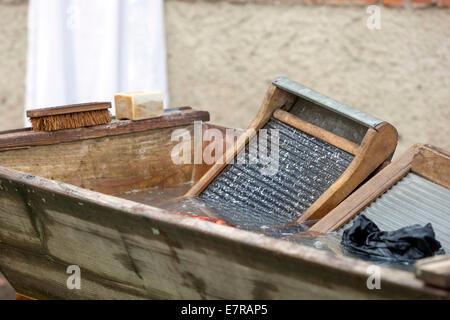 Wäsche waschen am alten Holz- waschbrett und Wanne waschen Kleidung Stockfoto