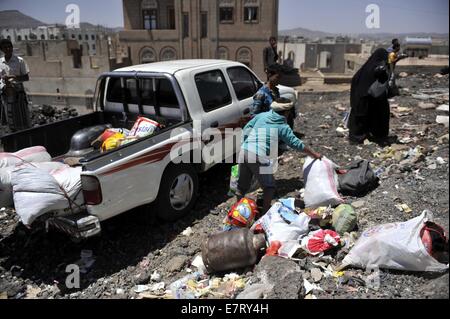 (140923)--SANAA, 23. September 2014 (Xinhua)--Jemeniten nach Zusammenstößen zwischen schiitischen Houthi-Rebellen und Armee in Sanaa, Jemen, am 23. September 2014 nach Hause zurückkehren. Die Huthi-Gruppe und die jemenitische Regierung Vertrag einen Waffenstillstand am Sonntag, Woche-langen Auseinandersetzungen, die mehr als 400 Tote Links ein Ende gesetzt. Huthi-Kämpfer haben ihre Kontrolle auf den meisten Teilen der Hauptstadt bis Dienstag, verschärft, Bereitstellung von Kämpfern um staatliche Einrichtungen und die Einrichtung von Kontrollpunkten in der Stadt zu schützen. (Xinhua/Hani Ali) Stockfoto