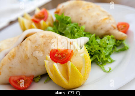 Tintenfisch, gefüllt mit Meeresfrüchten auf weißen Teller im restaurant Stockfoto