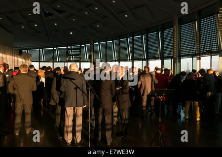 London, UK, 24. September 2014.  Markieren Sie den ersten Weltkrieg Centenary und 75. Jahrestag des Beginns des zweiten Weltkriegs, der Bürgermeister von London, Boris Johnson, erinnert an den Beitrag der Londoner Veteranen und militärische Wohltätigkeitsorganisationen bei einem speziellen Community-Empfang im Rathaus.  Im Bild: Gäste an der Rezeption im Abendlicht.  Bildnachweis: Stephen Chung/Alamy Live-Nachrichten Stockfoto