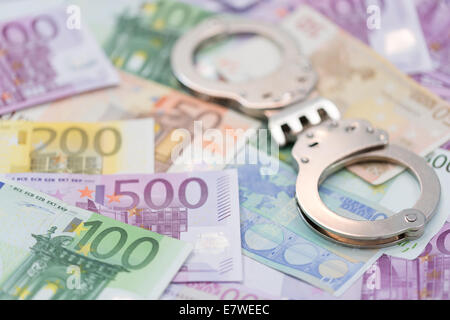 Polizeihandschellen und Euro-Geld Stockfoto