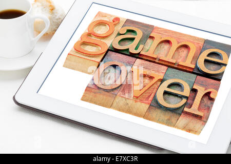 Spiel vorbei (Verlust oder Ausfall-Konzept) - Wörter in Vintage Holz Buchdruck Druckstöcken auf digitale Tablett mit Kaffee Stockfoto