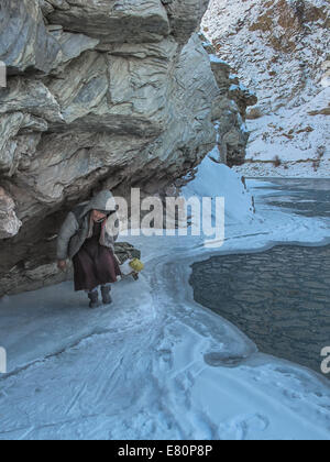 Porters zieht Trekker Gepäck auf Zanskar Fluss während Chadar Trek Stockfoto