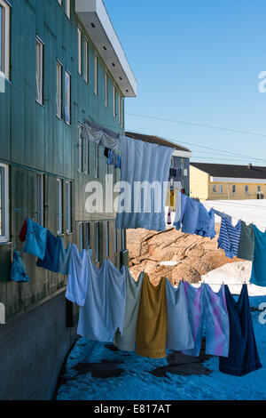 Wäsche hängen von einer Wäscheleine vor einem grünen Gebäude Stockfoto