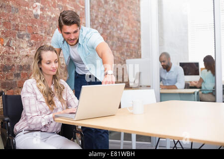 Geschäftsfrau im Rollstuhl, die Zusammenarbeit mit Kollegen Stockfoto