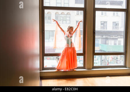 Tänzerin in Tanzstudio. Eine Frau am Fenster posiert. Stockfoto