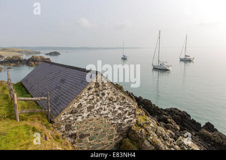 Segelboote vor Anker in der Morgendämmerung, Ynys Llanddwyn Island, Anglesey, North Wales, UK Stockfoto
