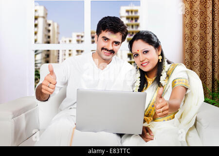 South Indian verheiratet paar sitzen mit Laptop nach Hause Stockfoto