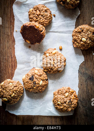 Hausgemachte Haferkekse mit Rosinen und Erdnüsse auf einem rustikalen Holztisch. Stockfoto