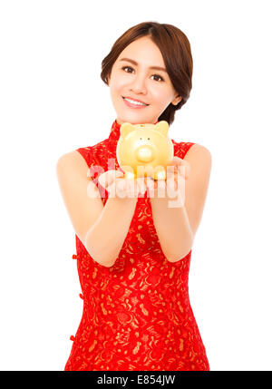 asiatische Frau hält eine goldene Sparschwein. Frohes neues Jahr Stockfoto