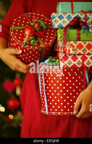 Eine Frau hält Weihnachten präsentiert Stockfoto