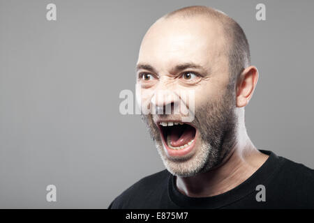 Porträt der böse Mann Sreaming isoliert auf grauem Hintergrund mit Exemplar Stockfoto