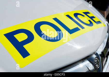 Das Wort Polizei auf einem Schild auf der Motorhaube eines weißen britischen Vauxhall Polizeiautos Stockfoto