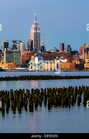 Das Empire State Building in Pastellfarben zum Gedenken an das christliche Ostern fest während der Dämmerung beleuchtet. Stockfoto