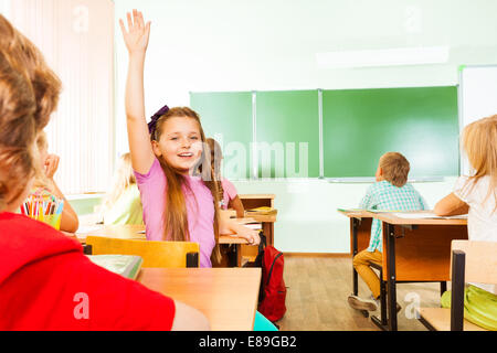 Mädchen hält die Hand von wandte sich wieder im Klassenzimmer Stockfoto