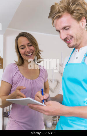 Frau, die er Befehl von Blumen, Verkäufer, Lächeln Stockfoto