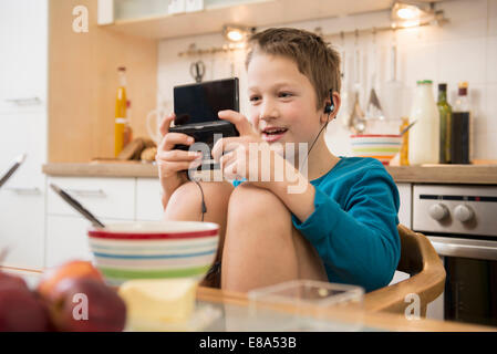 Junge Videospiel in Küche Stockfoto