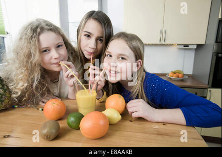 Mädchen in der Küche trinken Frucht-smoothie Stockfoto