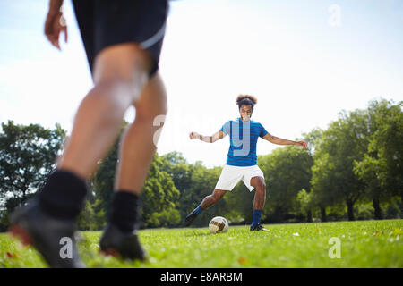 Junges Paar Fußball spielen zusammen im park Stockfoto