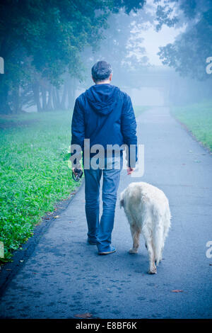 Mann geht mit seinem Hund in der Natur Stockfoto