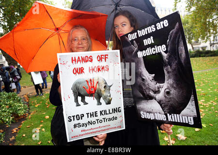 London, UK. 4. Oktober 2014. Demonstranten mit Plakaten und Bannern bei Global Marsch für Elefanten und Nashörner, London, England. Regen Dämpfen nicht die Geister von den Demonstranten, die das Bewusstsein für die Notlage der Elefanten und Nashörner, die unter anderem von Wilderern für Elfenbein und Souvenirs getötet werden. Bildnachweis: Paul Brown/Alamy Live-Nachrichten Stockfoto