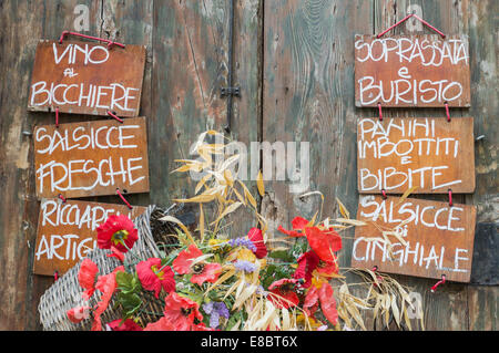 Menü auf Holzschilder mit Korb mit Blumen, Arezzo, Toskana, Italien Stockfoto