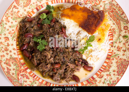 Iranische (persische) Kraut und Lamm Koresh mit persischer Safranreis serviert. Das Fleisch ist mit Massen von Petersilie langsam geschmort. Stockfoto