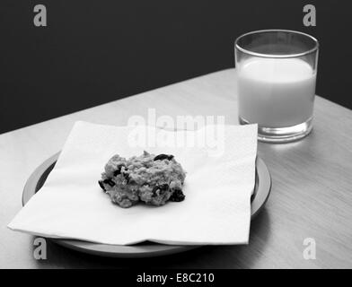 Frische Haferflocken Rosinen Cookies serviert mit einem Glas kalter Milch - monochrome Verarbeitung Stockfoto