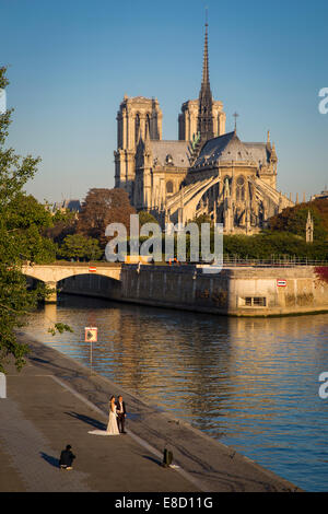 Hochzeitspaar posiert für Fotos am frühen Morgen unter der Kathedrale Notre Dame, Paris, Frankreich Stockfoto