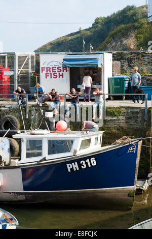 Angelboot/Fischerboot / Boote vertäut / gefesselt vor einem Kiosk / shop verkaufen frischen Fisch am Meer Hafen / Mevagissey Hafen in Cornwall. VEREINIGTES KÖNIGREICH. Stockfoto