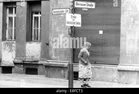 Blick auf die desolate Straße der Bernauer Straße in Berlin, 7. Juli 1961. Die Häuser auf der anderen Straßenseite gehören nach West-Berlin. 13. August 1961 wurden am Tag des Baus der Berliner Mauer, 9. November 1989, am Tag der Fall der Berliner Mauer, der Bundesrepublik und der DDR durch den Eisernen Vorhang zwischen Ost und West getrennt. Stockfoto