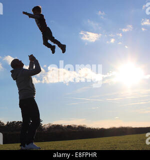 Vater Sohn in die Luft werfen Stockfoto