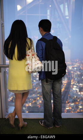 Rückansicht von wenigen Touristen bewundern die Aussicht von der Spitze des The Shard in London bei Sonnenuntergang Stockfoto