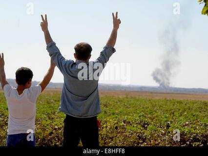 Suruc, Türkei. 8. Oktober 2014. Türkische Kurden jubelten als US militärische hit islamischer Staat Ziele in Kobane Syrien. Hunderte von türkischen Kurden kamen zu Marsitpinar eine Provinz in Suruc, Türkei, über ein Feld in Kobane sehen wo Amerika Luftangriffe gegen den Dschihad Terrorgruppe islamischer Staat geführt hat. © Gail Orenstein/ZUMA Draht/Alamy Live-Nachrichten Stockfoto