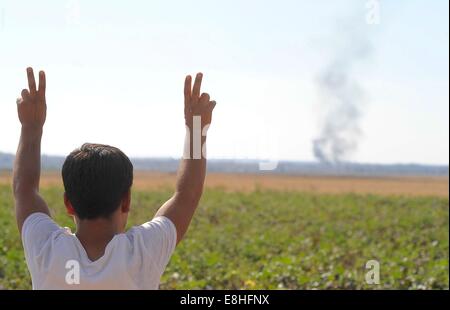 Suruc, Türkei. 8. Oktober 2014. Türkische Kurden jubelten als US militärische hit islamischer Staat Ziele in Kobane Syrien. Hunderte von türkischen Kurden kamen zu Marsitpinar eine Provinz in Suruc, Türkei, über ein Feld in Kobane sehen wo Amerika Luftangriffe gegen den Dschihad Terrorgruppe islamischer Staat geführt hat. © Gail Orenstein/ZUMA Draht/Alamy Live-Nachrichten Stockfoto