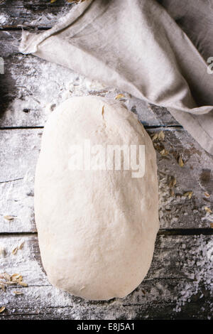 Brot backen. Teig auf Holztisch mit Mehl. Ansicht von oben. Stockfoto