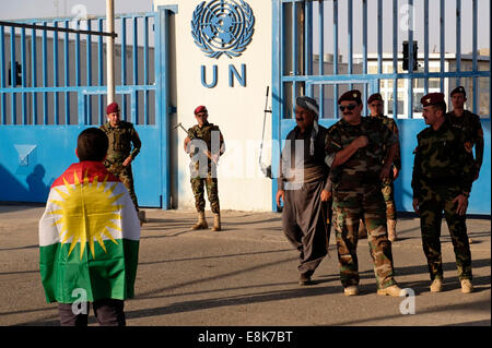 Eine junge kurdische Junge verpackt mit der kurdischen Flagge steht vor dem UN-Hauptquartier in der Stadt Erbil Arbil oder Irbil Dinkel auch die Hauptstadt der Region Kurdistan im Nordirak. Stockfoto