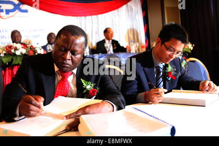 Harare. 10. Oktober 2014. Noar Gwariro (L), CEO von The Zimbabwe Power Company (ZPC) und Sinohydros Vertreter in Simbabwe Wu Yifeng unterzeichnen die Angebote bei der feierlichen Unterzeichnung des Projekts Erweiterung in Harare, Simbabwe, 10. Oktober 2014. Der ZPC und Chinas Sinohydro am Freitag unterzeichnete einen Vertrag für die Erweiterung des Hwange Kraftwerk von 600 Megawatt zu einem Preis von 1,17 Milliarden US-Dollar. © Xinhua/Alamy Live-Nachrichten Stockfoto