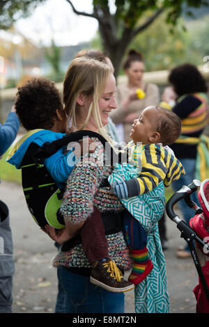 Aberystwyth Wales UK, Samstag, 11. Oktober 2014 Gruppe von Müttern mit ihren kleinen Kindern statt auf ihren Körper in Schlingen schließen treffen sich spazieren Gruppe am letzten Tag der internationalen Babytragen Week 2014. Nicht weit verbreitet durch moderne Industriegesellschaften, Babytragen fördert die Bindung, stillen unterstützt, helfen Kampf postpartale Depression und erleichtert die Pflege. Bildnachweis: Keith Morris/Alamy Live News Stockfoto