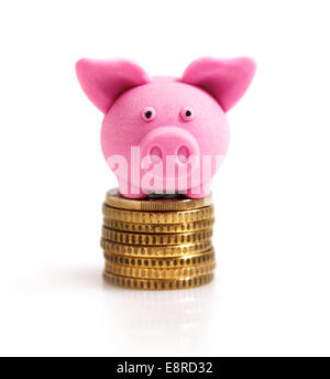 Rosa Schweinchen auf Münzen. Isoliert auf weiss Stockfoto