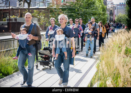 Ca. 15 Mitglieder des Arbeitskreises NYC Dads feiern International Babytragen Week mit einem Spaziergang auf der High Line Stockfoto