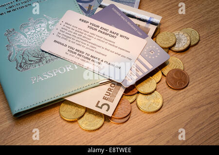 Britischer Pass mit einer EHIC-Karte und Euro-Münzen Stockfoto