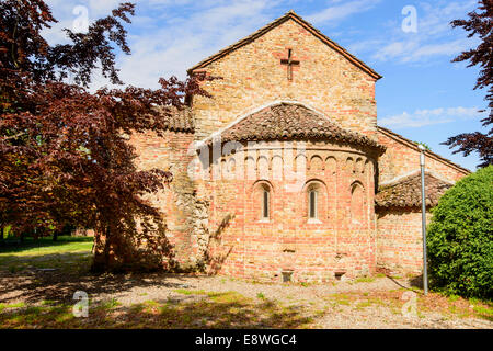 Außenansicht der Apsis und Südseite der alten romanischen Kirche im kleinen Dorf im Piemont, in hellen Frühling Licht gedreht Stockfoto