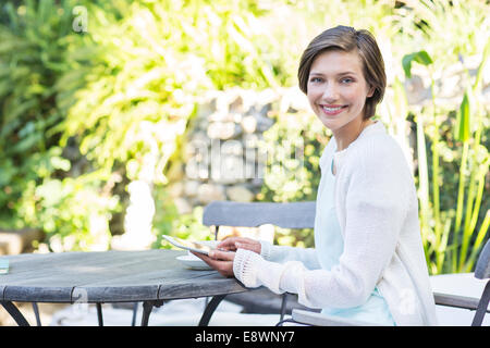 Frau mit digital-Tablette am Tisch im freien Stockfoto