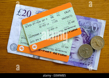 UK-Bahntickets und Geld auf einer Tischplatte fotografiert. Stockfoto