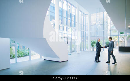 Geschäftsleute Händeschütteln im Bürogebäude Stockfoto