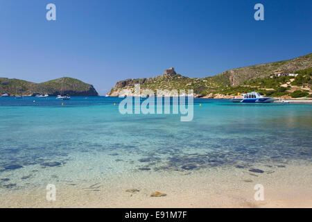 Insel Cabrera, Mallorca, Balearen, Spanien. Blick über die Bucht nach Schloss aus dem 14. Jahrhundert, Boot am Kai. Stockfoto