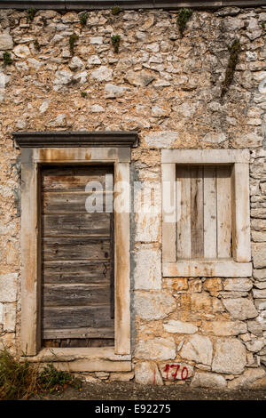 Alten, verlassenen Haus mit Tür und Fenster schließen mit Holzbohlen, Insel Korcula, Kroatien Stockfoto