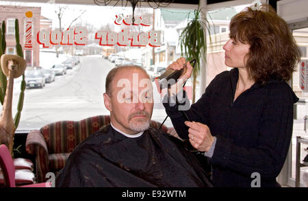 Weibliche Friseur schneidet Mannes Haare im Friseursalon Stockfoto